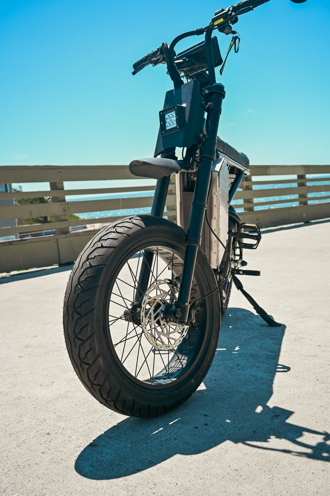 ZR Custom from a low front angle on the pier, LED headlight and front fork prominent