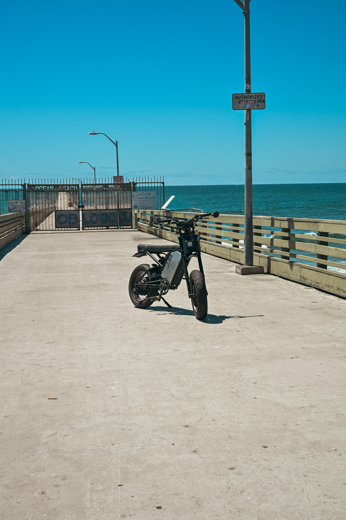 ZR Custom alone on the wide concrete pier, Ocean Beach Fishing Pier gate and open ocean behind